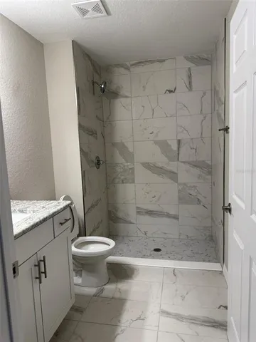 a bathroom with a shower and a toilet