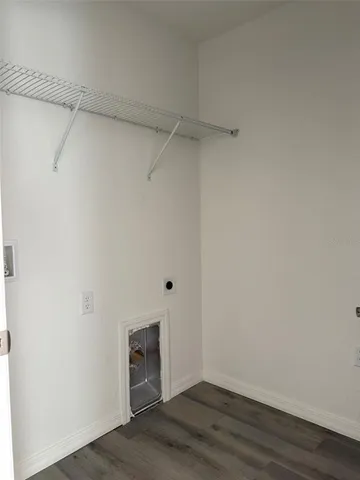 a view of a room with wooden floor