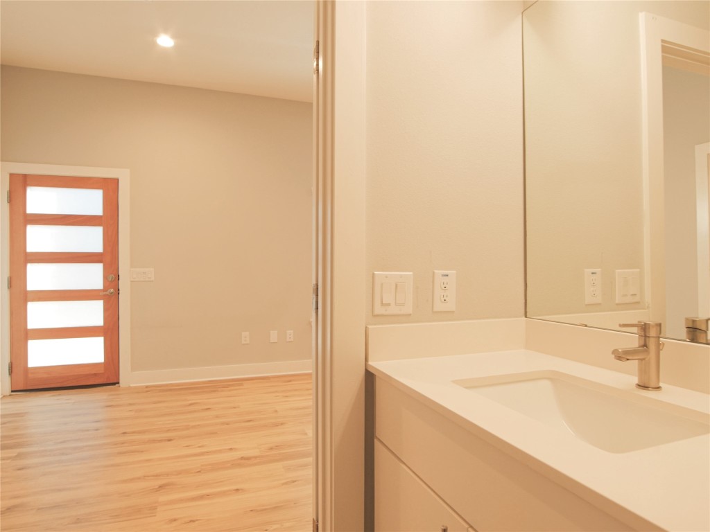 6014 Fairway Street, Unit 2 Austin, TX 78741 - Photo 11 of 24 a bathroom with a granite countertop sink and a bathtub