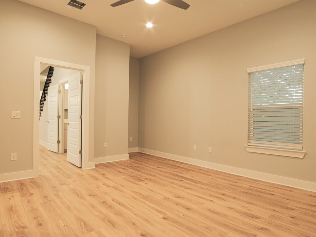 6014 Fairway Street, Unit 2 Austin, TX 78741 - Photo 14 of 24 an empty room with wooden floor and windows