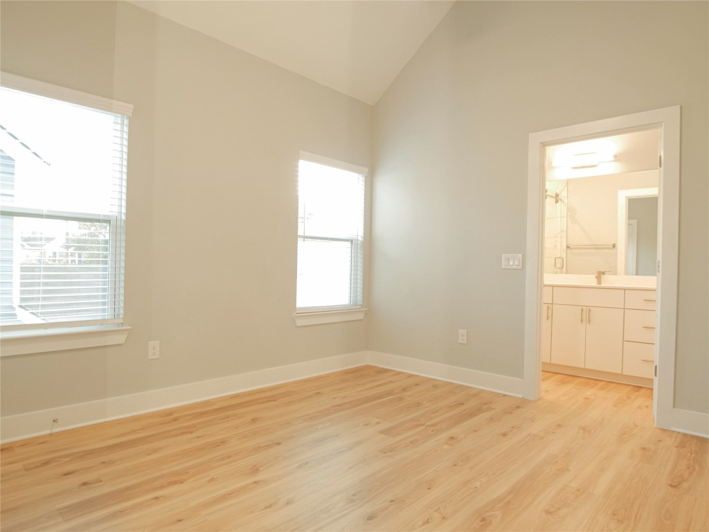 6014 Fairway Street, Unit 2 Austin, TX 78741 - Photo 16 of 24 an empty room with wooden floor and windows