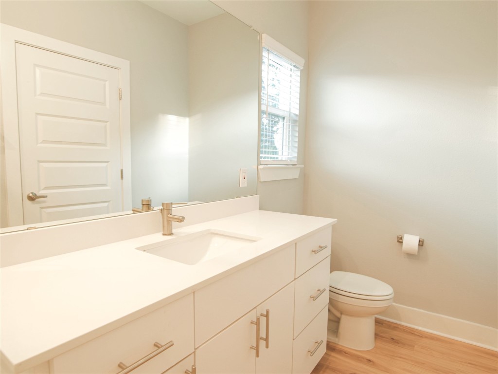6014 Fairway Street, Unit 2 Austin, TX 78741 - Photo 19 of 24 a bathroom with a sink a toilet and a window