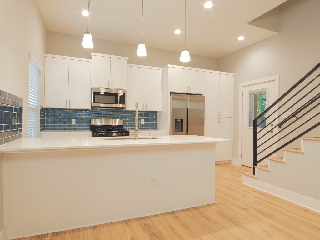 6014 Fairway Street, Unit 2 Austin, TX 78741 - Photo 6 of 24 a large kitchen with stainless steel appliances a refrigerator a stove a sink and a oven