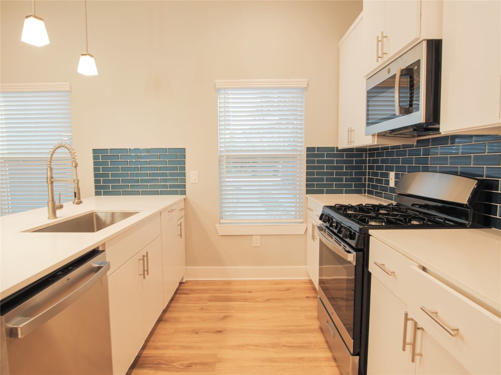 6014 Fairway Street, Unit 2 Austin, TX 78741 - Photo 8 of 24 a kitchen with granite countertop a sink stove and cabinets