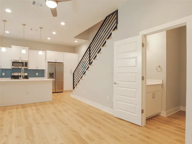 a bathroom with a granite countertop sink and a bathtub