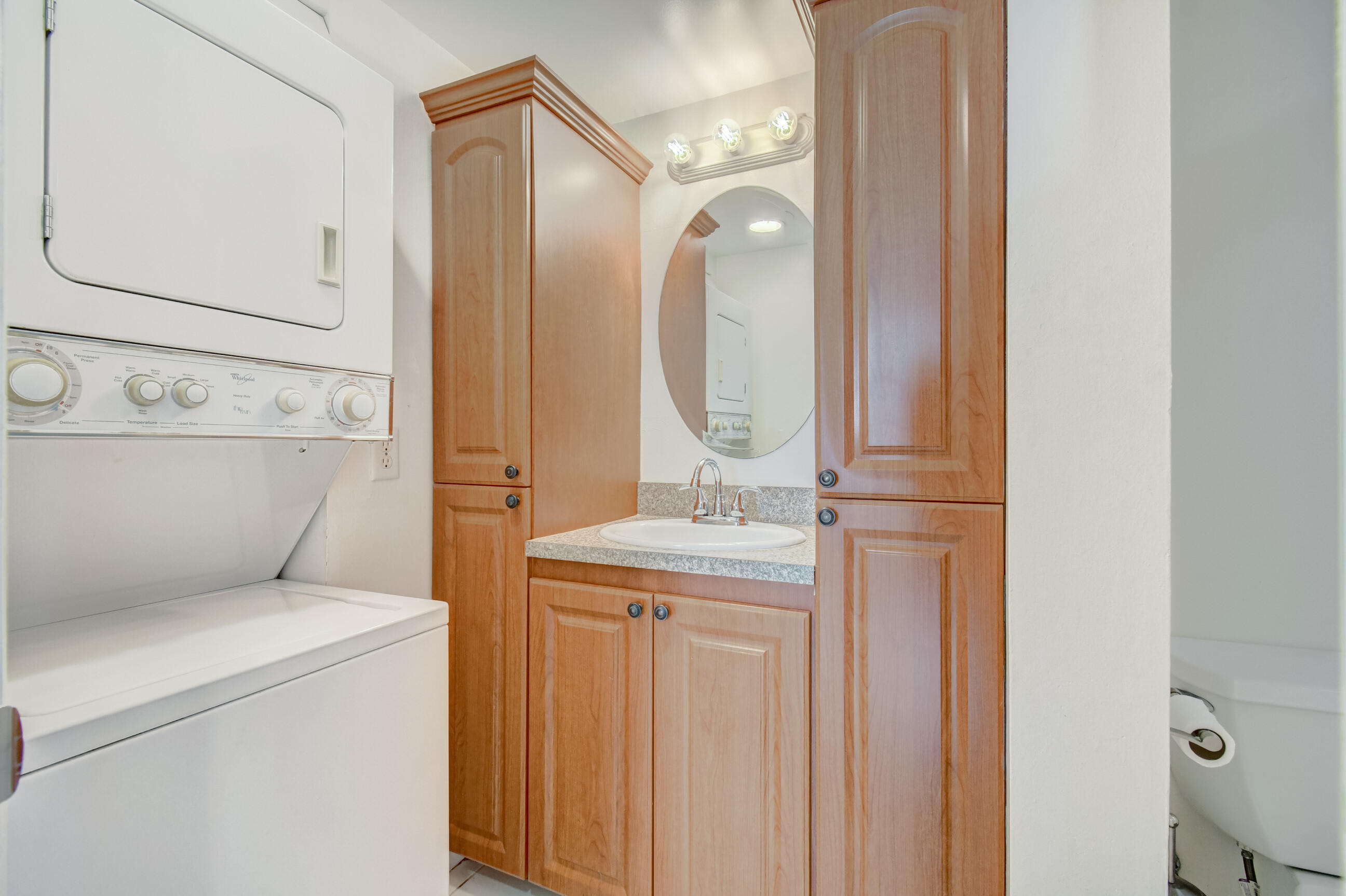61 Capri B Delray Beach, FL 33484 - Photo 11 of 46 a bathroom with a granite countertop sink and a mirror