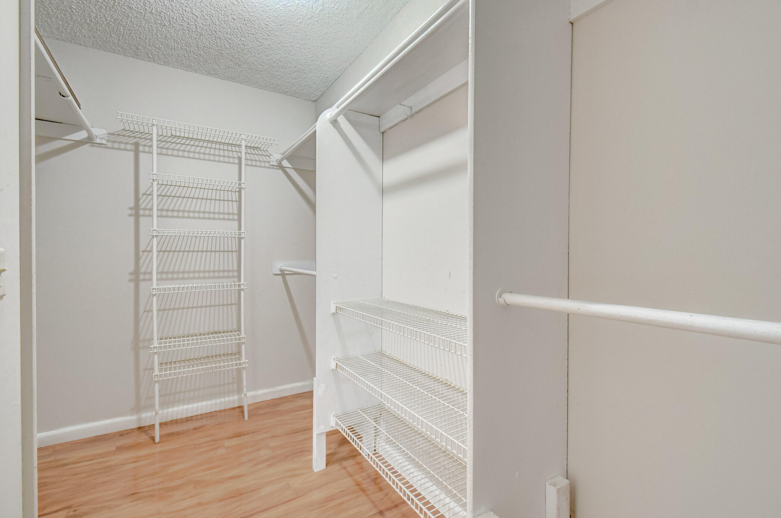 61 Capri B Delray Beach, FL 33484 - Photo 25 of 46 a view of walk in closet with empty racks