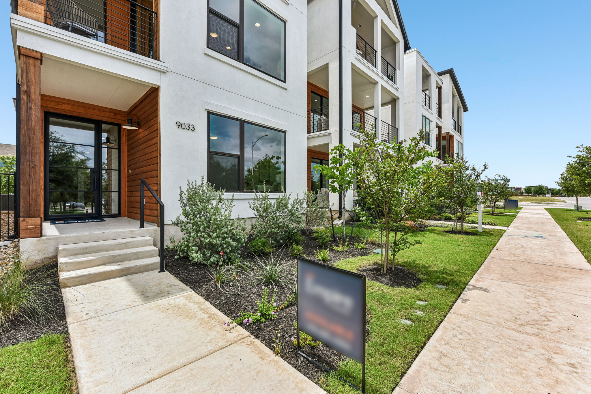 9033 Cattle Baron Path Austin, TX 78747 - Photo 4 of 40 Modern architecture meets natural light in this well-appointed new construction, featuring sleek lines and inviting green spaces.