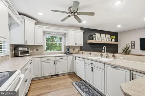 a kitchen with a sink cabinets and window