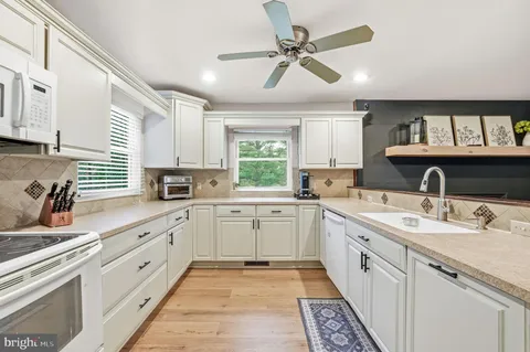 a large white kitchen with a window