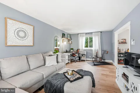 a living room with furniture large window and a flat screen tv