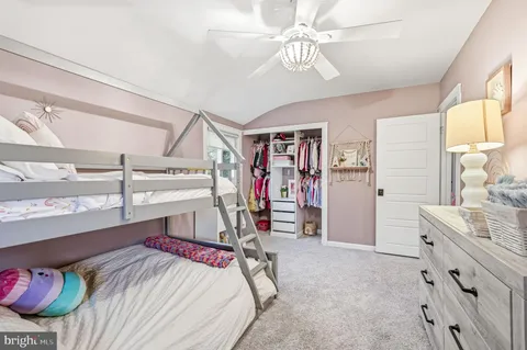 a view of a bedroom with furniture and windows