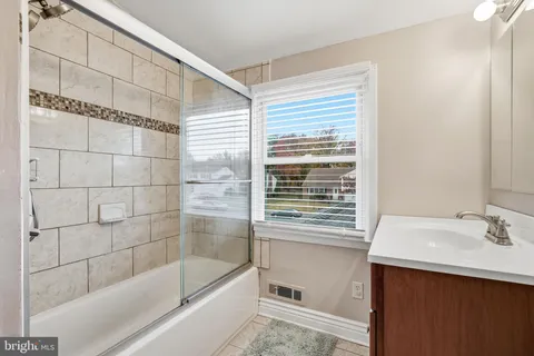 a bathroom with a bathtub and a sink
