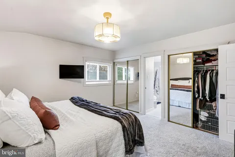 a bedroom with a bed and a television