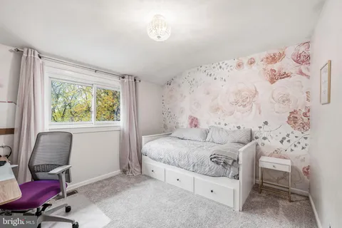 a bedroom with a bed and chair