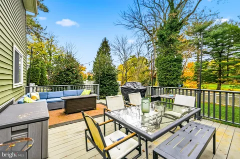 a view of a balcony with wooden floor and outdoor seating