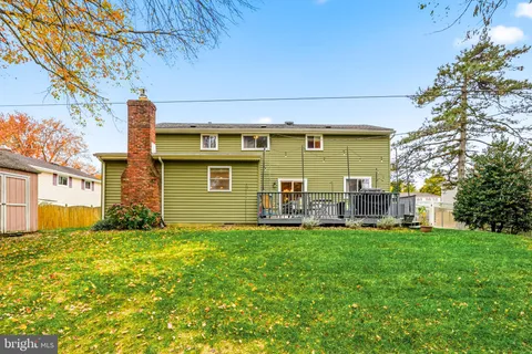 a view of a house with a yard and sitting area