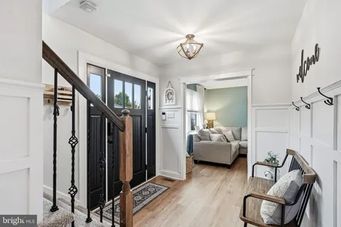 a view of a livingroom with furniture and hallway