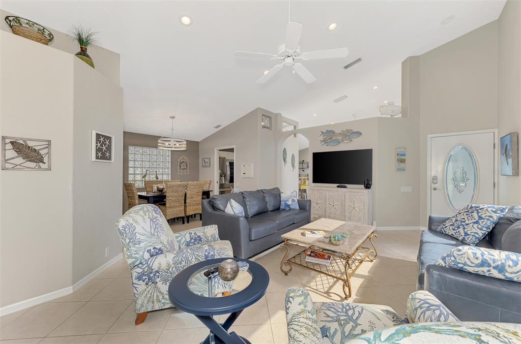 335 St George Court, Unit 1 Venice, FL 34293 - Photo 23 of 87 a living room with furniture a table and a flat screen tv