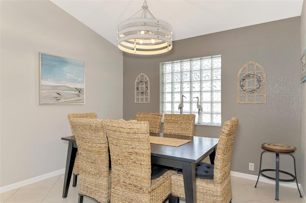 335 St George Court, Unit 1 Venice, FL 34293 - Photo 25 of 87 a view of a dining room with furniture window and wooden floor