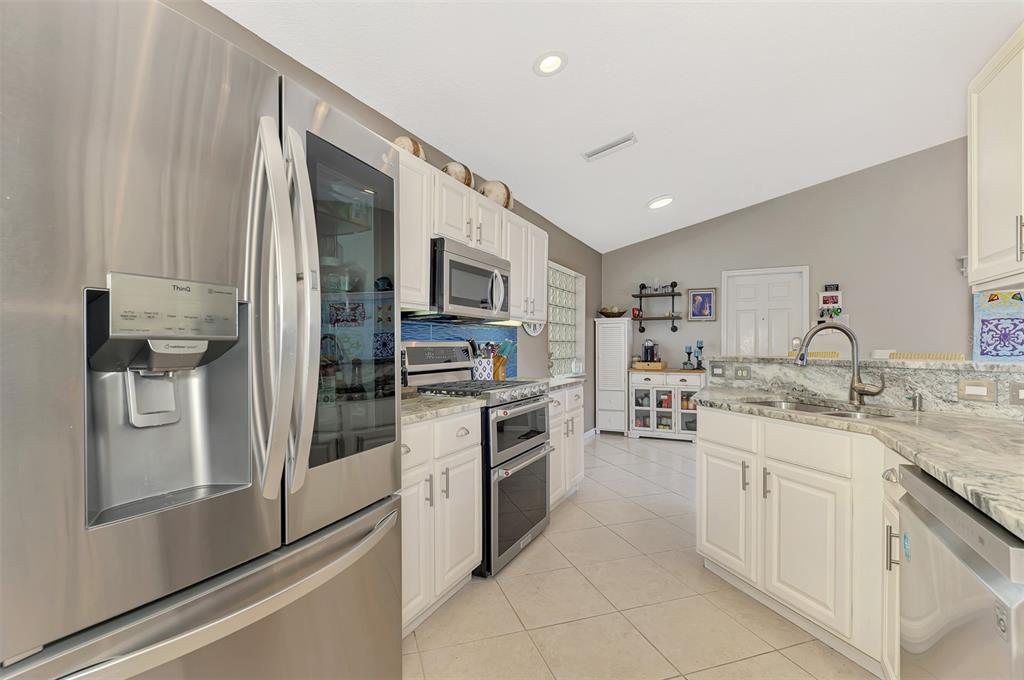 335 St George Court, Unit 1 Venice, FL 34293 - Photo 28 of 87 a kitchen with a sink stainless steel appliances and cabinets