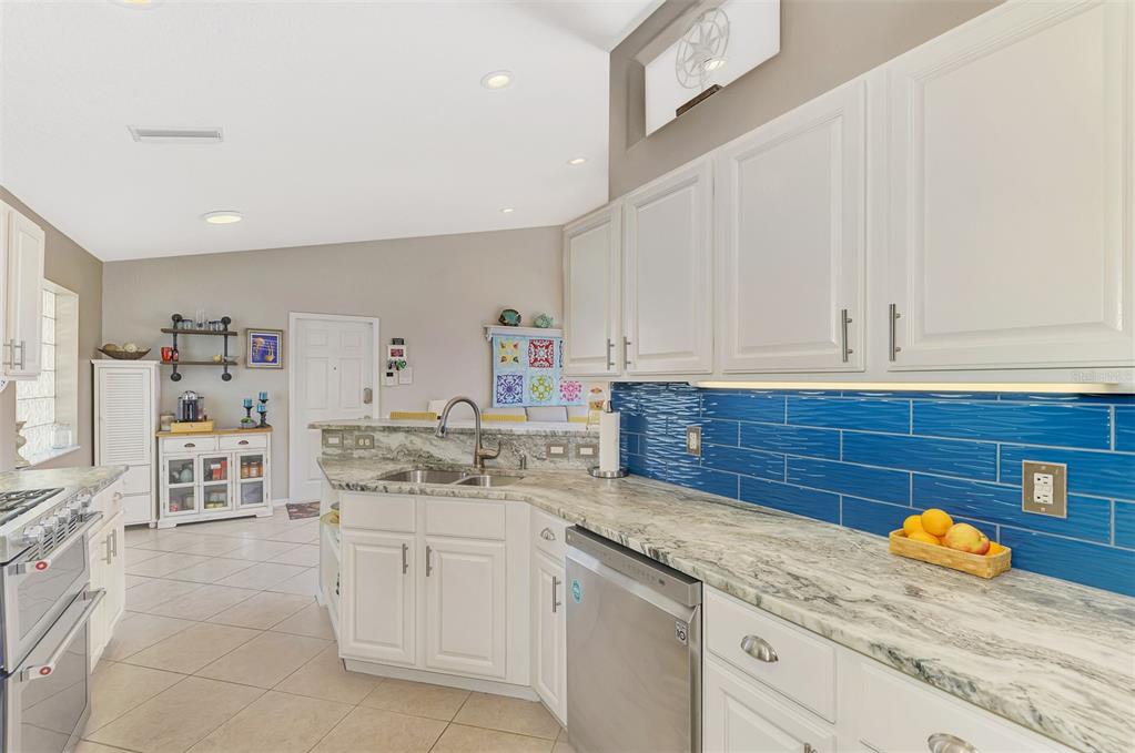 335 St George Court, Unit 1 Venice, FL 34293 - Photo 29 of 87 a kitchen with granite countertop a sink and cabinets
