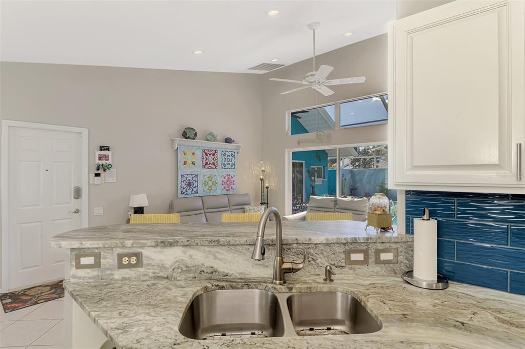 335 St George Court, Unit 1 Venice, FL 34293 - Photo 30 of 87 a kitchen with a sink and a refrigerator