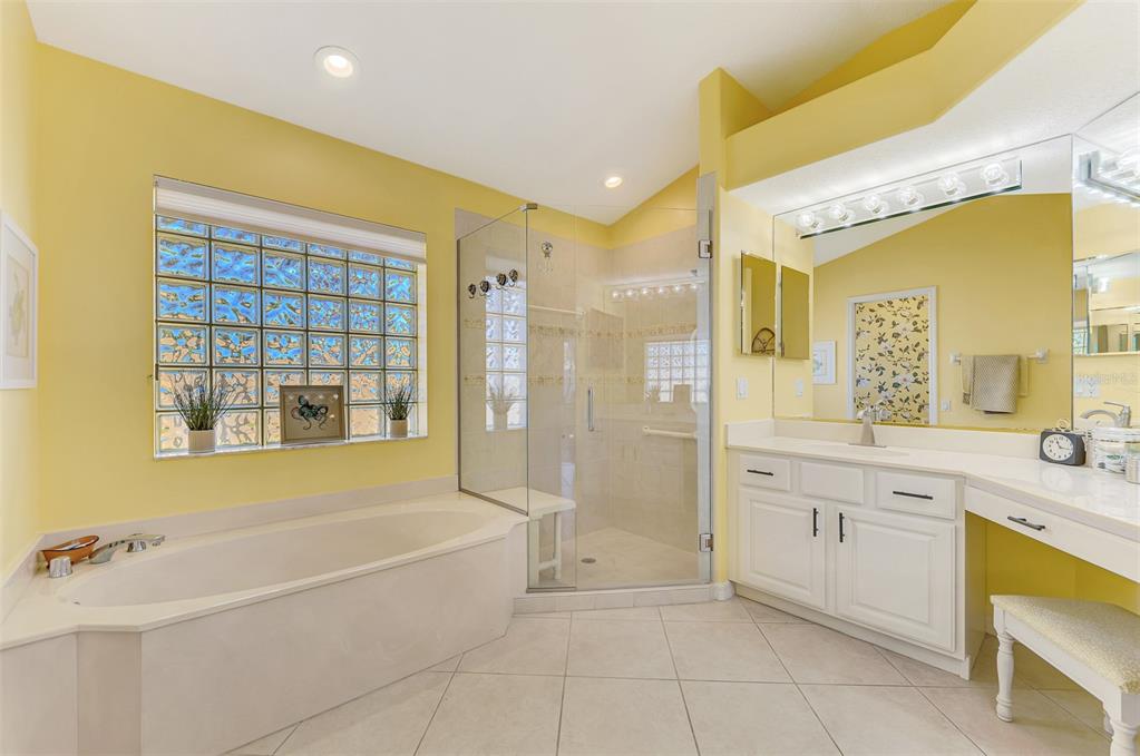 335 St George Court, Unit 1 Venice, FL 34293 - Photo 42 of 87 a spacious bathroom with a tub sink shower and mirror