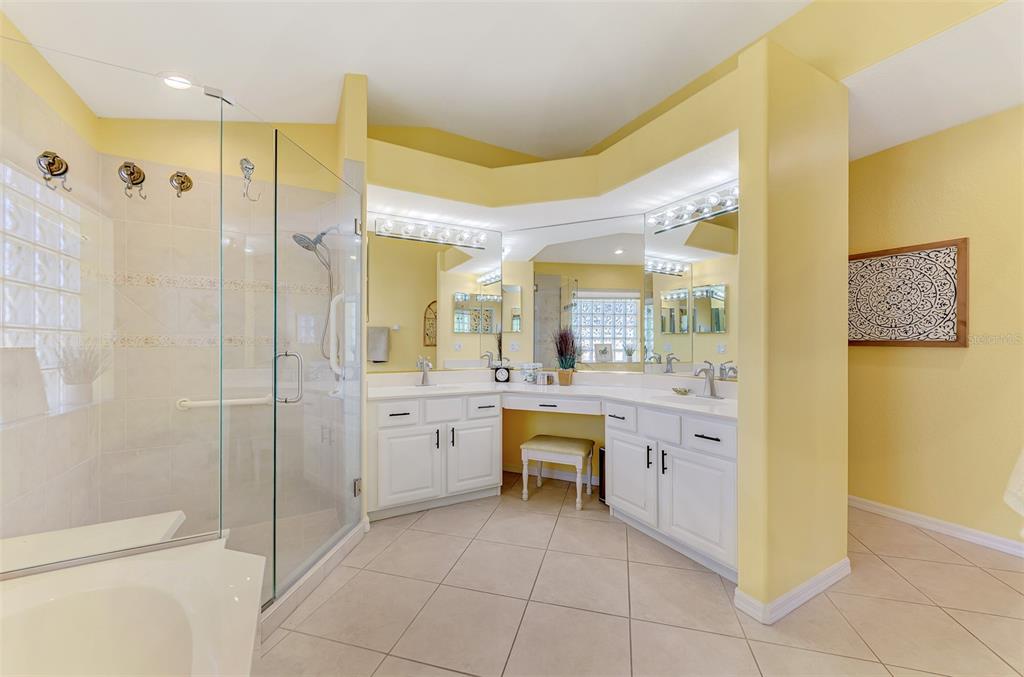 335 St George Court, Unit 1 Venice, FL 34293 - Photo 43 of 87 a bathroom with a granite countertop sink mirror and shower