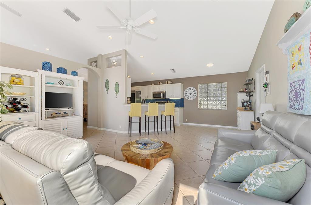 335 St George Court, Unit 1 Venice, FL 34293 - Photo 50 of 87 a living room with furniture and a flat screen tv