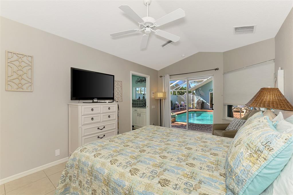335 St George Court, Unit 1 Venice, FL 34293 - Photo 52 of 87 a bedroom with a bed and a flat tv screen on dresser