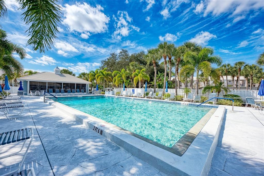 335 St George Court, Unit 1 Venice, FL 34293 - Photo 63 of 87 a view of backyard with swimming pool and outdoor seating