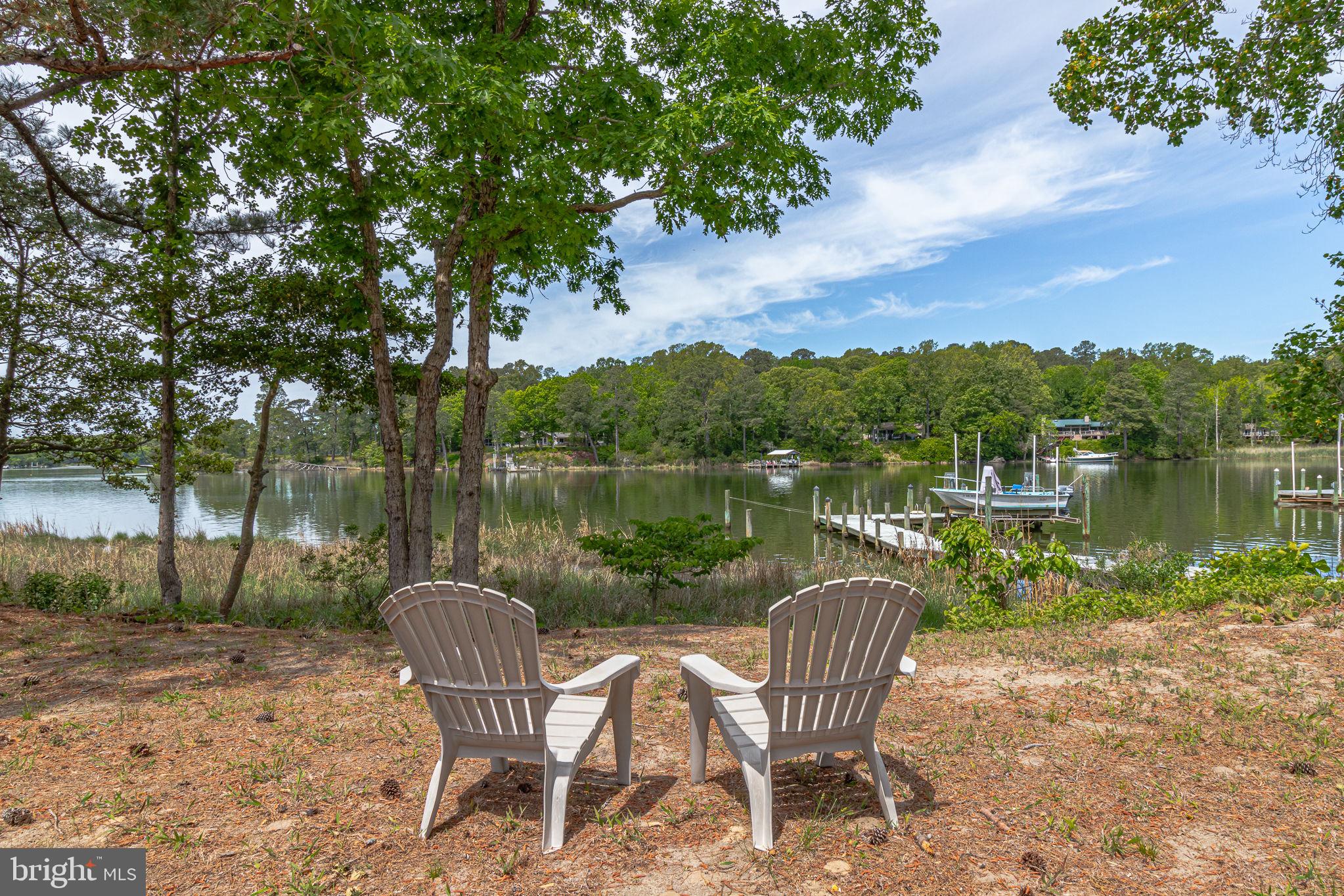 1280 Kelley Neck Road Lancaster, VA 22503 - Photo 44 of 51 a view of a lake with a table and chairs