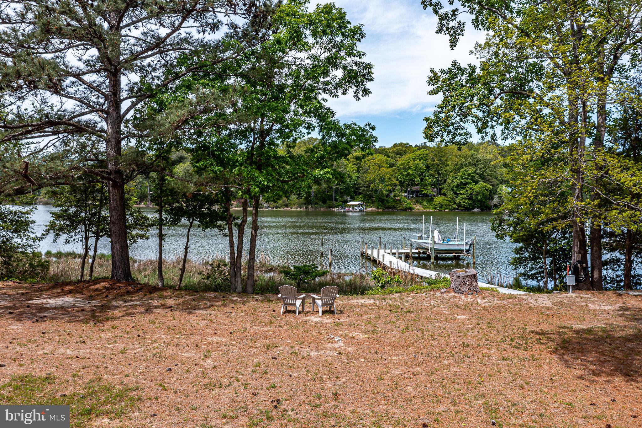 1280 Kelley Neck Road Lancaster, VA 22503 - Photo 45 of 51 a view of a lake with a bench and trees