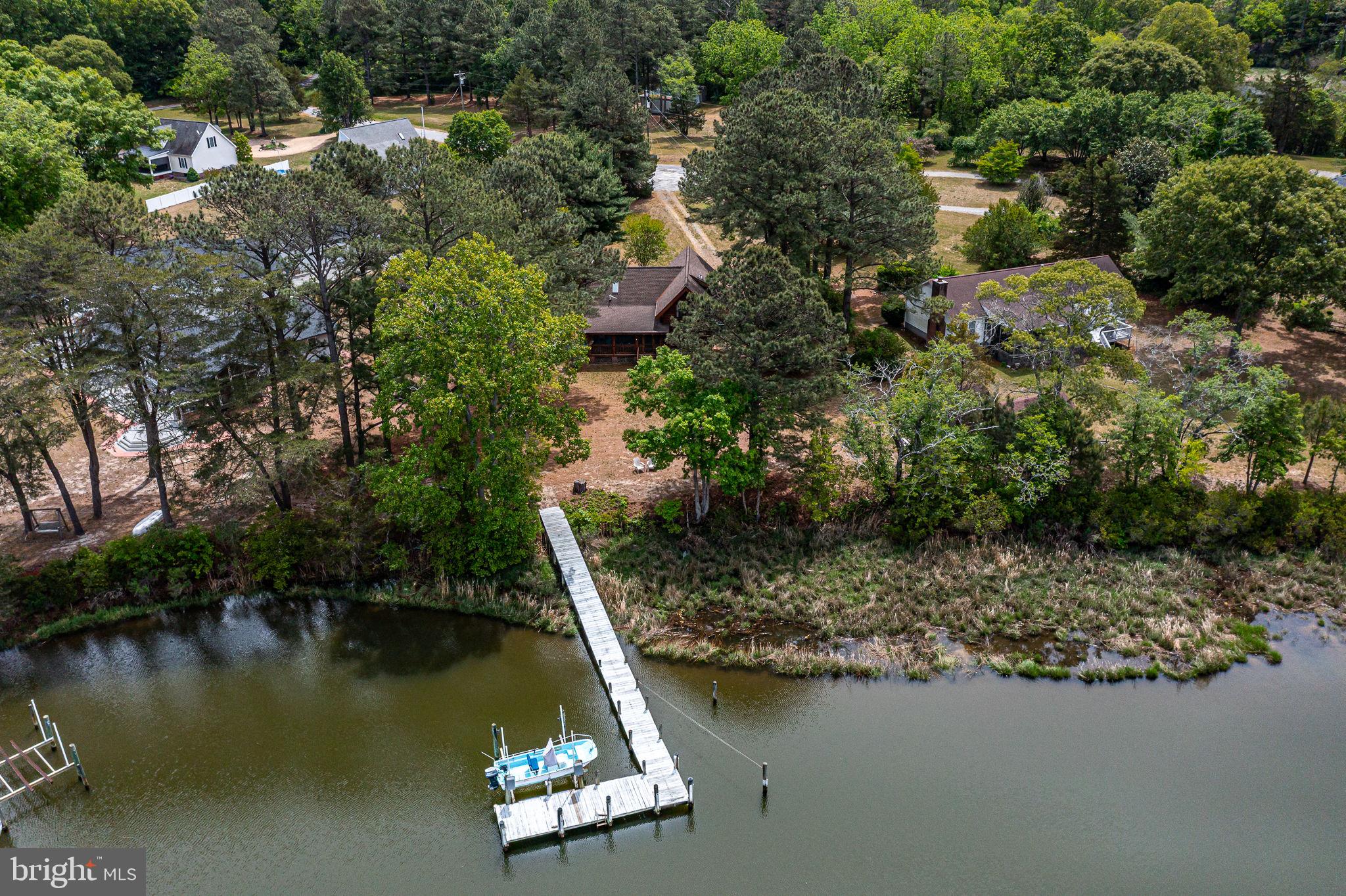 1280 Kelley Neck Road Lancaster, VA 22503 - Photo 5 of 51 an aerial view of a house with a yard lake and outdoor seating