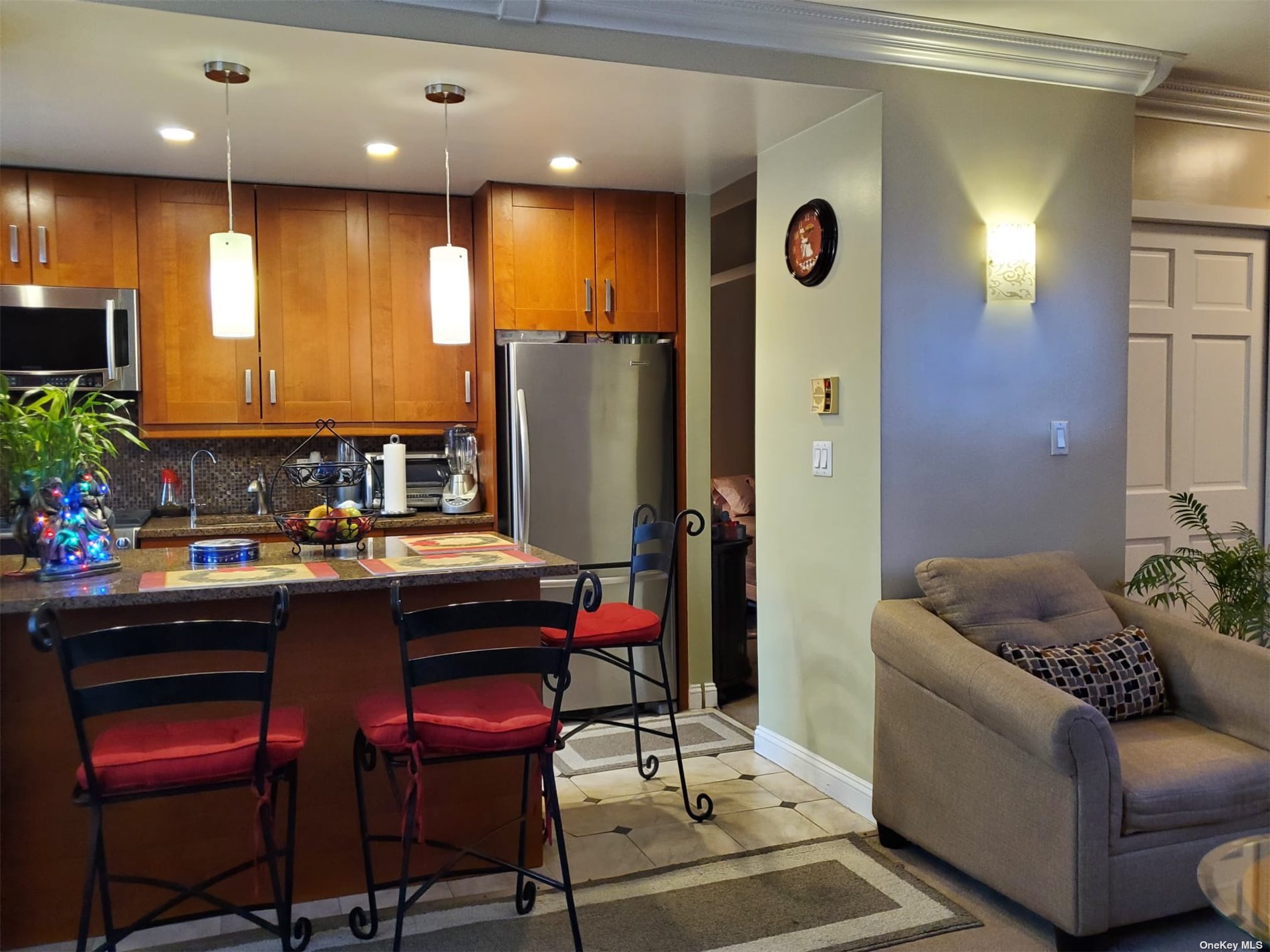 a kitchen with stainless steel appliances granite countertop a refrigerator and a dining table