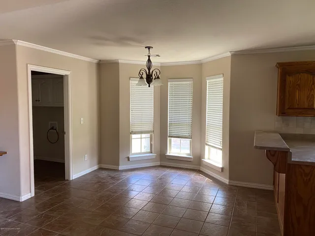 a view of a room with large windows and a chandelier