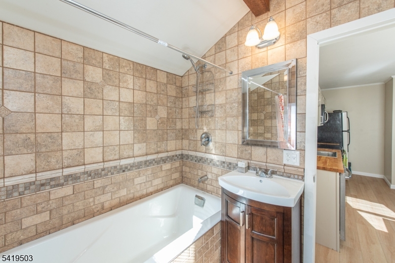 40 Kingsland Road West Milford, NJ 07421 - Photo 13 of 20 a bathroom with a granite countertop sink a mirror and bathtub