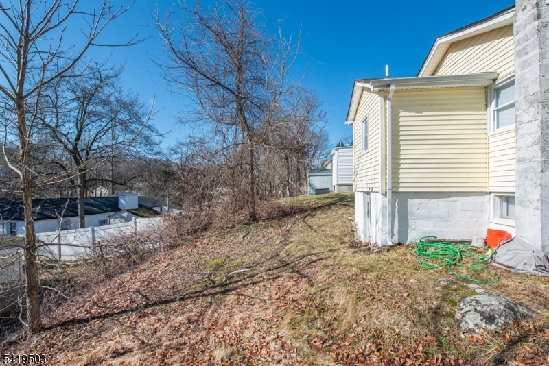 40 Kingsland Road West Milford, NJ 07421 - Photo 19 of 20 a backyard of a house with wooden fence and large trees