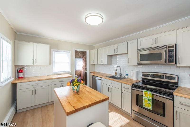 40 Kingsland Road West Milford, NJ 07421 - Photo 5 of 20 a kitchen with a sink stove and microwave