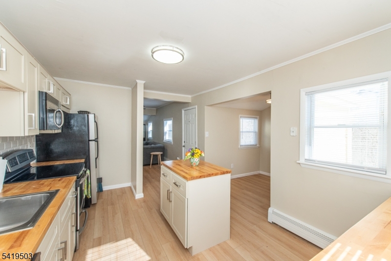 40 Kingsland Road West Milford, NJ 07421 - Photo 7 of 20 a kitchen with stainless steel appliances granite countertop a sink dishwasher stove top oven and refrigerator with wooden floor