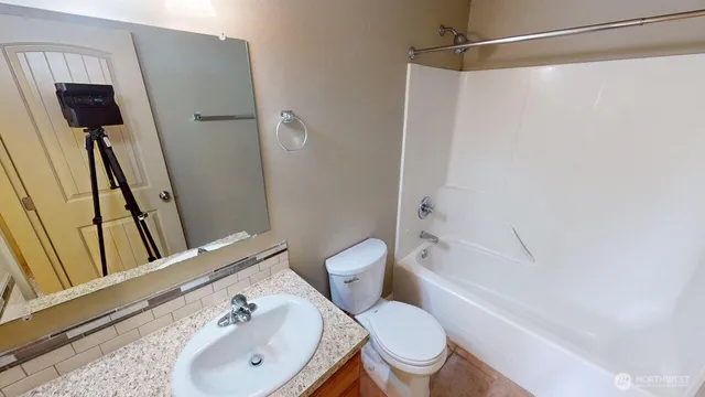 a bathroom with a shower a toilet and a sink