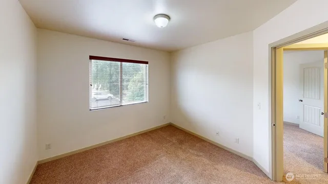 an empty room with windows and closet