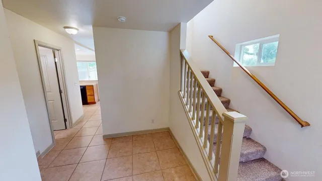 a view of entryway with stairs and wooden floor