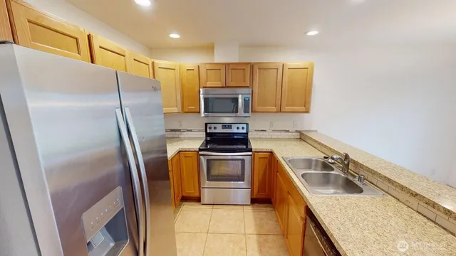 a kitchen with a refrigerator sink and microwave