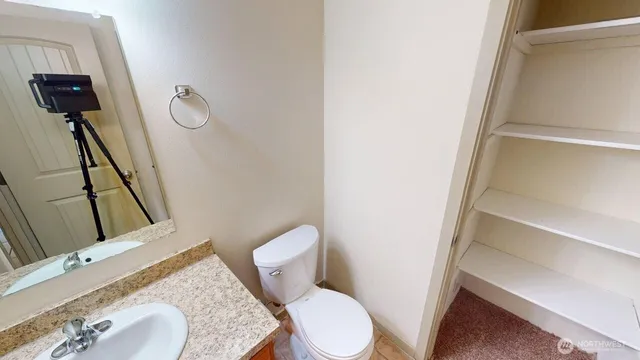 a white toilet sitting next to a bathroom sink