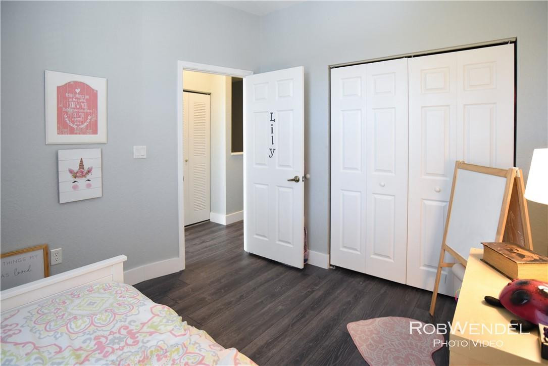 2851 Prospect Road, Unit 405 Tamarac, FL 33309 - Photo 13 of 25 a bedroom with a bed and wooden floor