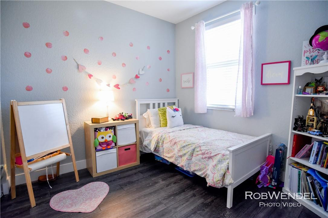 2851 Prospect Road, Unit 405 Tamarac, FL 33309 - Photo 14 of 25 a bedroom with a bed and a bookshelf