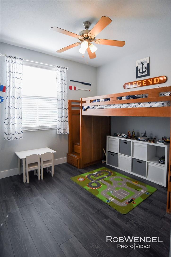 2851 Prospect Road, Unit 405 Tamarac, FL 33309 - Photo 15 of 25 a living room with a table or chairs and a wooden floor