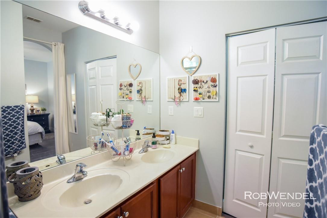 2851 Prospect Road, Unit 405 Tamarac, FL 33309 - Photo 20 of 25 a bathroom with a sink and a mirror